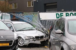 Auto door hek bij kringloopwinkel